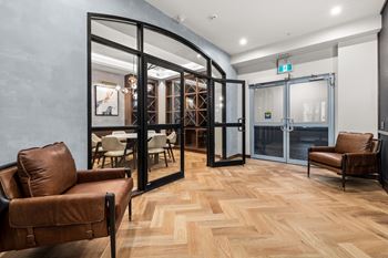 A room with wooden flooring and a glass door.